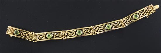 An Edwardian 9ct gold and peridot set fancy link bracelet, 6.75in.